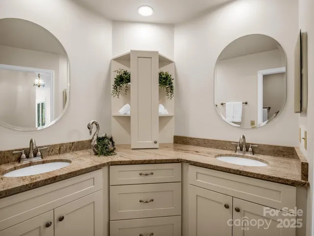 a bathroom with double vanity sinks and a mirror