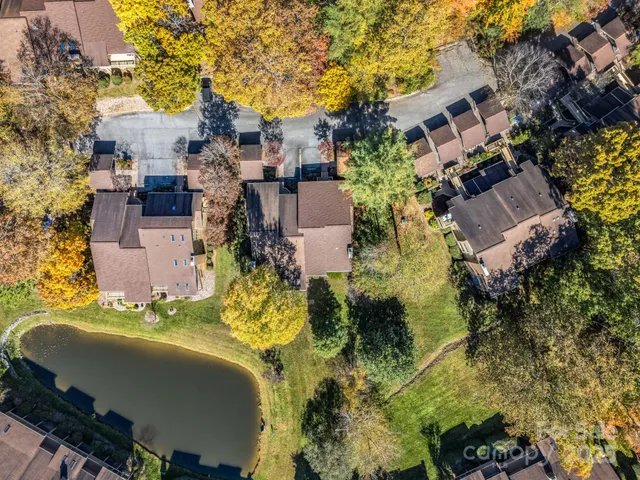 an aerial view of a house with a yard swimming pool and outdoor seating