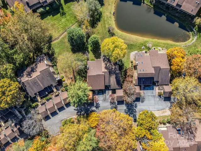 an aerial view of a house with a swimming pool and outdoor seating
