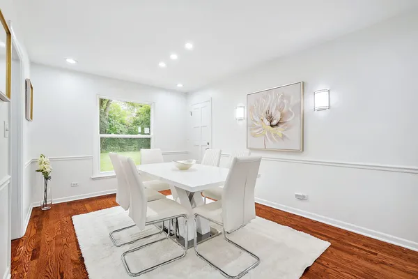 a view of a dining room with furniture and wooden floor