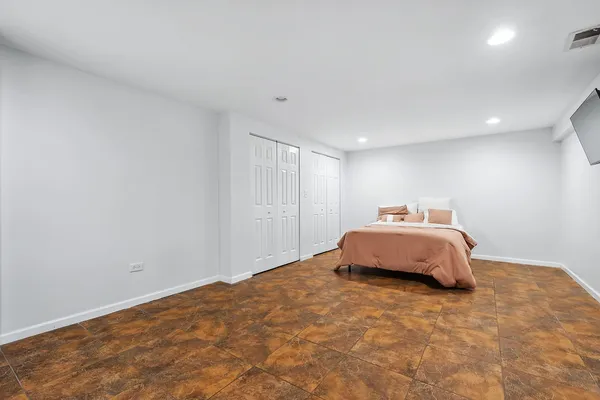 a living room with furniture a flat screen tv and kitchen view