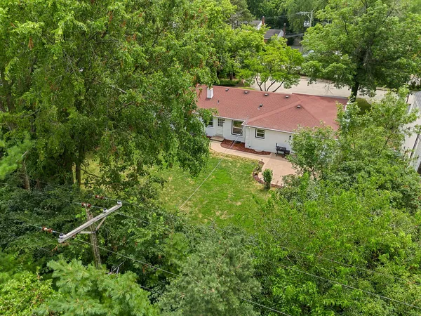 an aerial view of a house with a yard and lake view