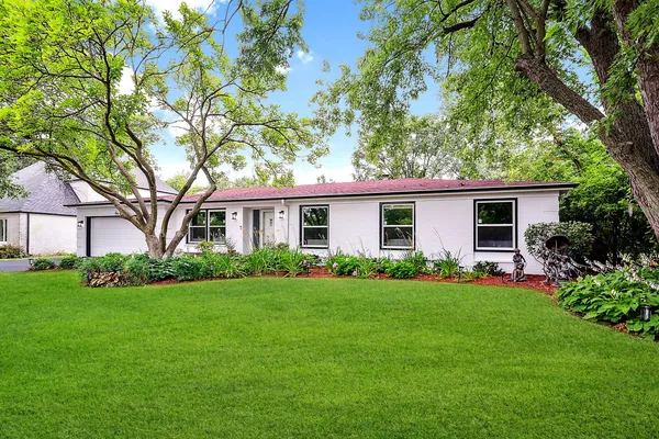 a front view of house with yard and green space