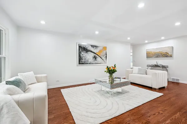 a living room with furniture and wooden floor