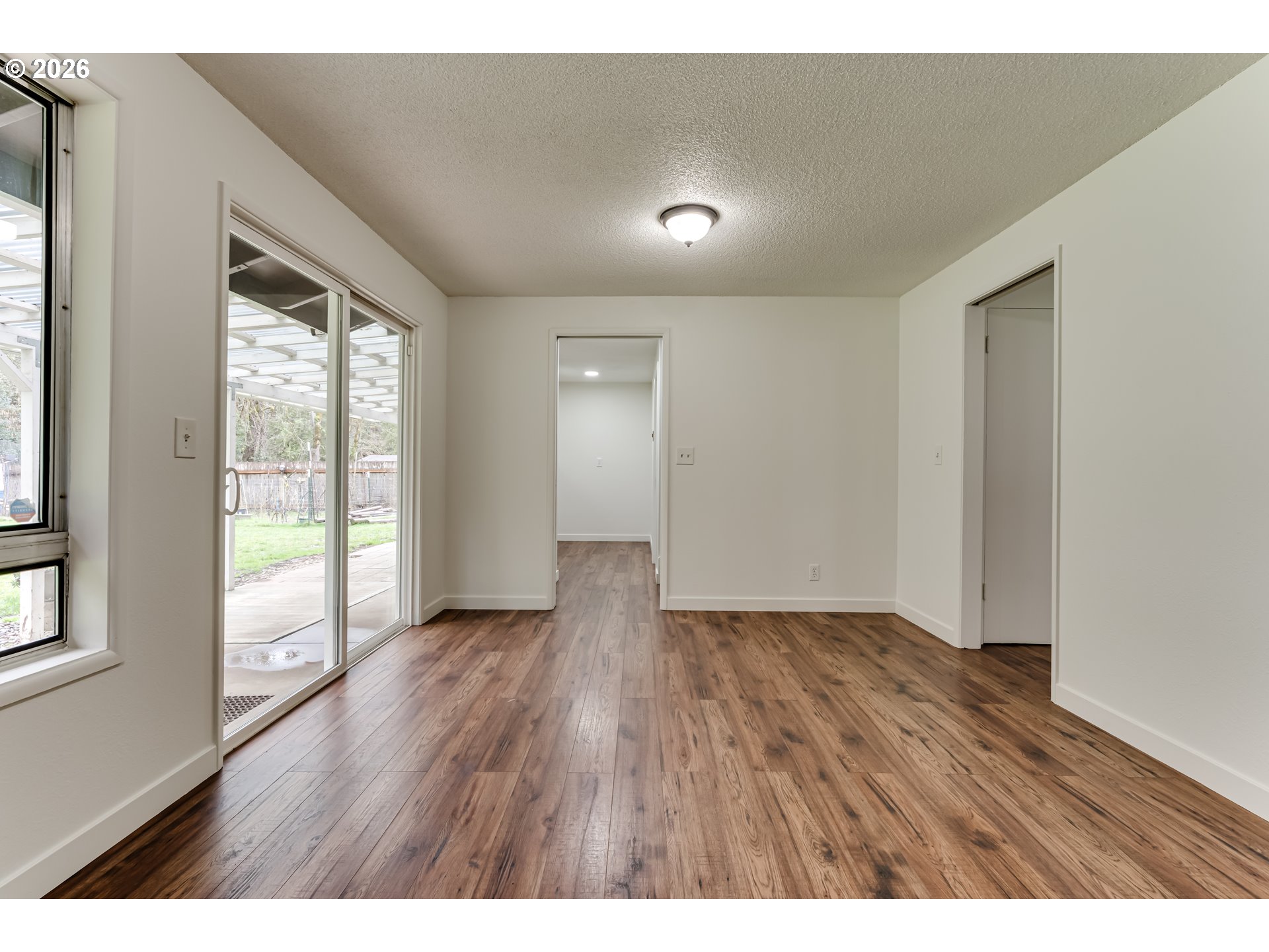38730 Natures Garden Street Springfield, OR 97478 - Photo 12 of 37 a view of an empty room with wooden floor and a window