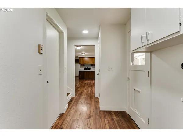 a view of hallway with wooden floor