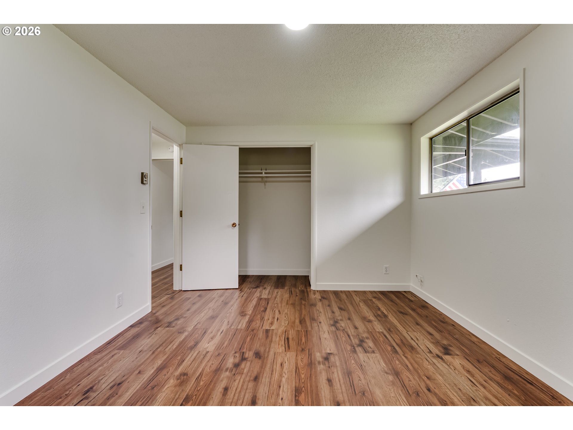 38730 Natures Garden Street Springfield, OR 97478 - Photo 17 of 37 a view of an empty room with wooden floor and a window