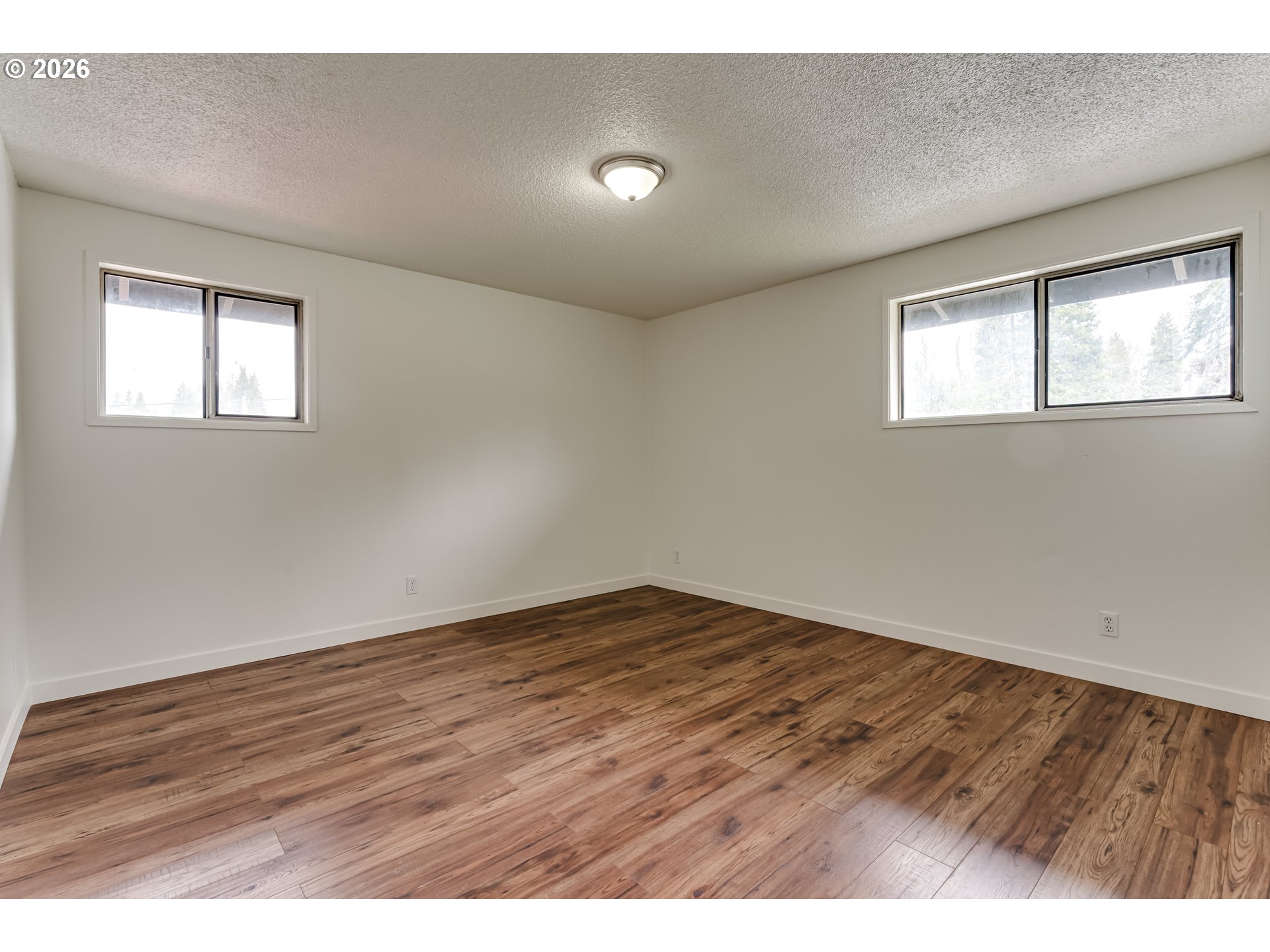 38730 Natures Garden Street Springfield, OR 97478 - Photo 24 of 37 an empty room with wooden floor and windows