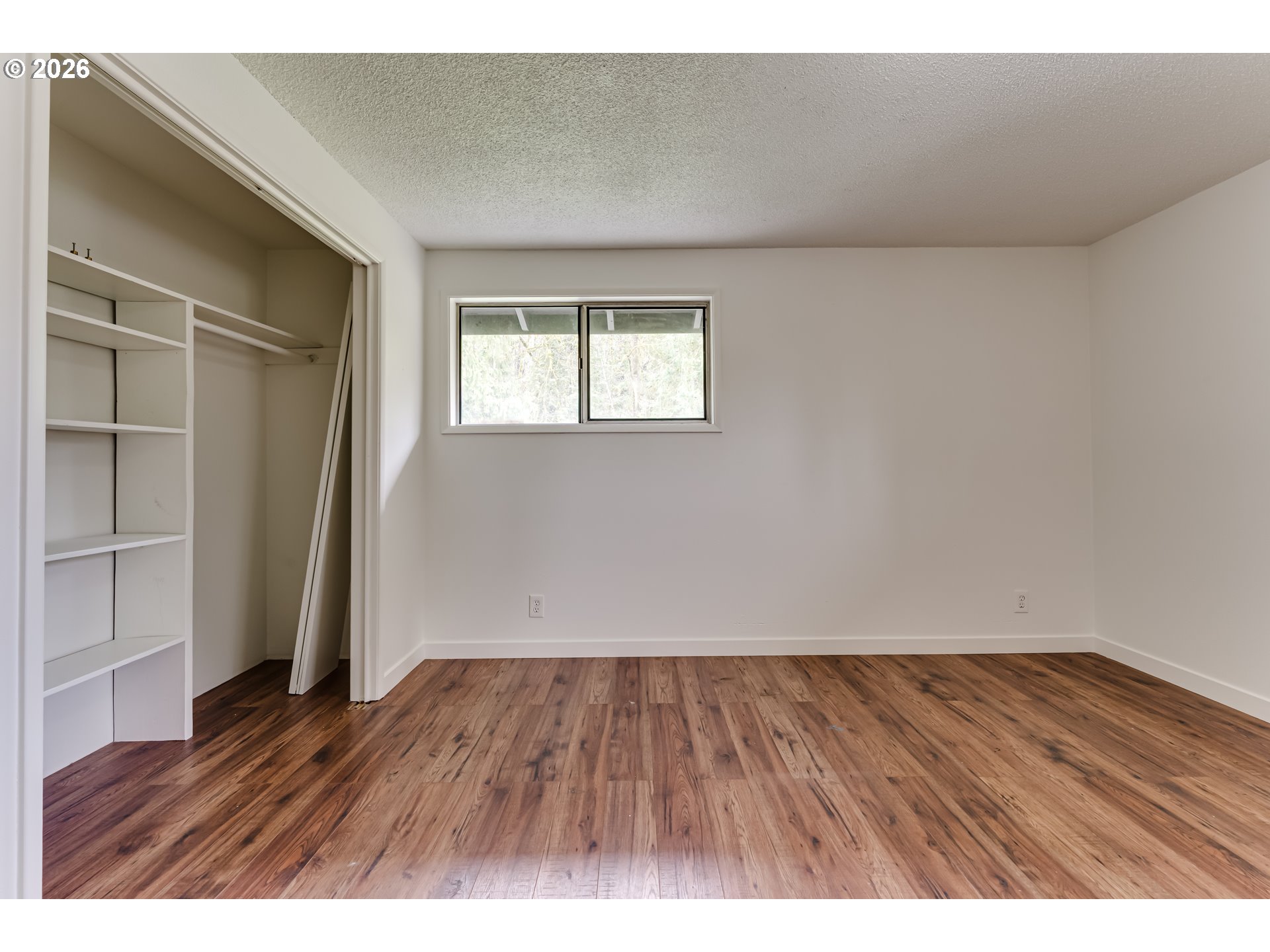 38730 Natures Garden Street Springfield, OR 97478 - Photo 28 of 37 a view of an empty room with wooden floor and a window