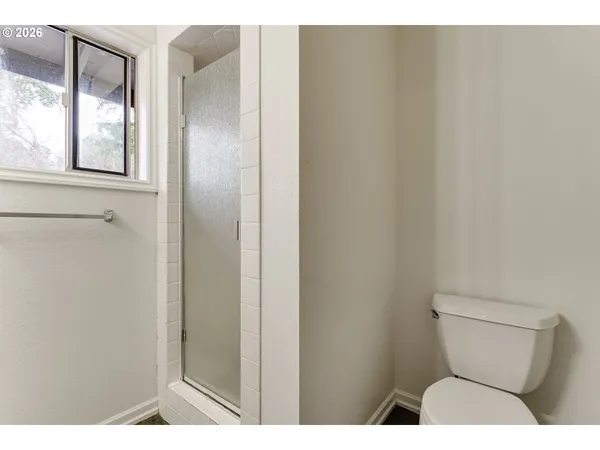 a bathroom with a toilet and a shower