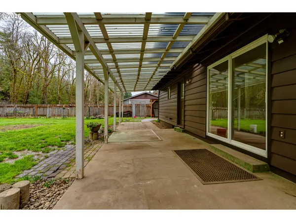 a view of front a house with a yard and large trees