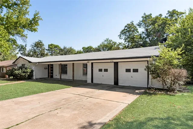 a front view of house with yard and trees