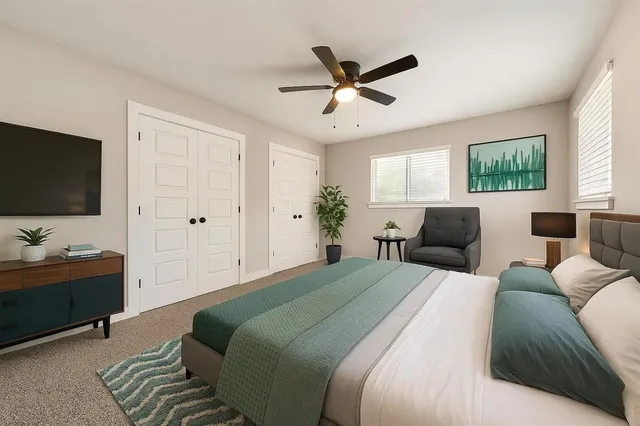 a bedroom with a bed and a flat screen tv