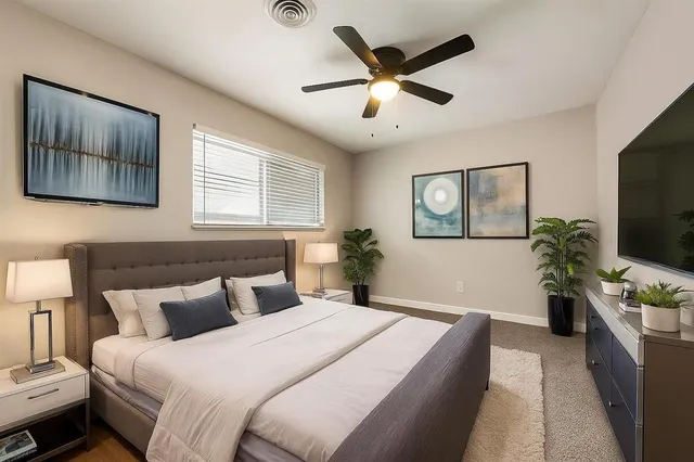 a bedroom with a large bed and a flat screen tv