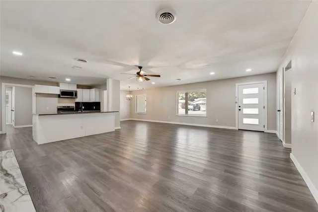 a view of a kitchen with a sink and a stove top oven