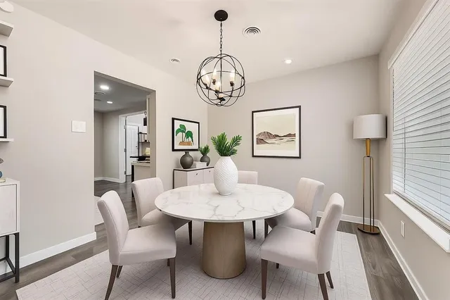 a dining room with furniture a rug and a chandelier