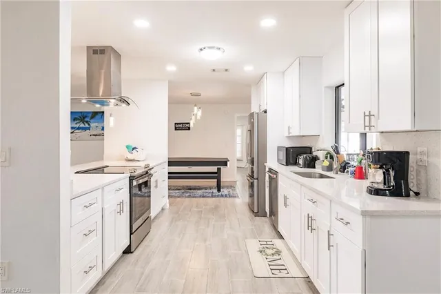 a kitchen with stainless steel appliances a stove top oven and cabinets