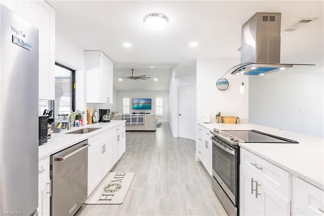 a kitchen with a sink stove and cabinets