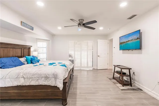 a bedroom with a bed and a flat screen tv