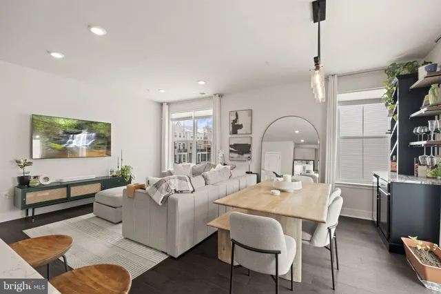 a living room with furniture a rug and a book shelf