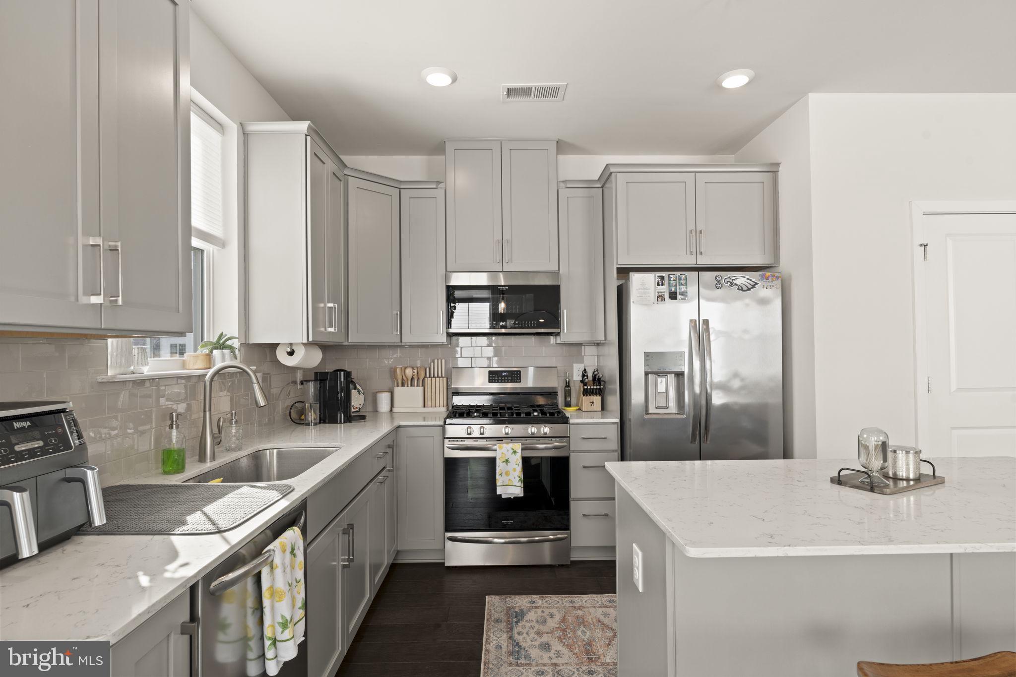 917 Anvil Court Phoenixville, PA 19460 - Photo 14 of 34 a kitchen with stainless steel appliances a refrigerator stove and sink
