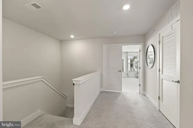a spacious bedroom with a large bed couch and a window