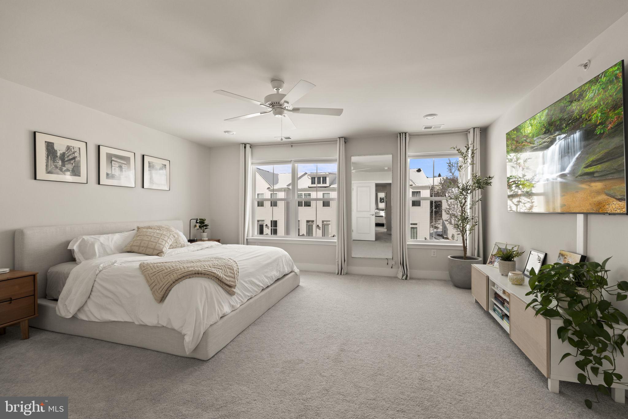 917 Anvil Court Phoenixville, PA 19460 - Photo 20 of 34 a spacious bedroom with a large bed couch and a window