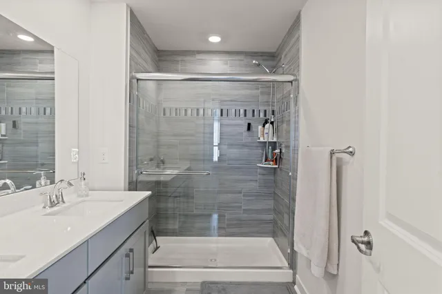 a bedroom with a bed a computer on the desk and chair