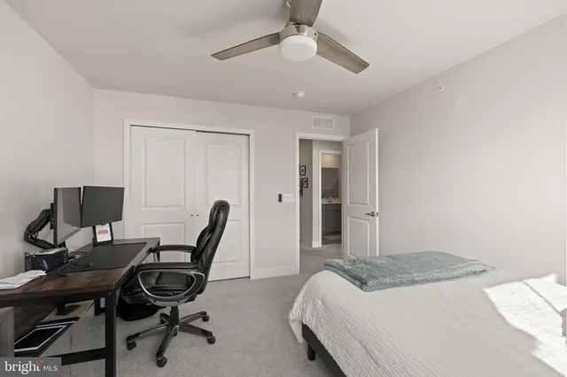 a bathroom with a toilet a sink a mirror a vanity and window