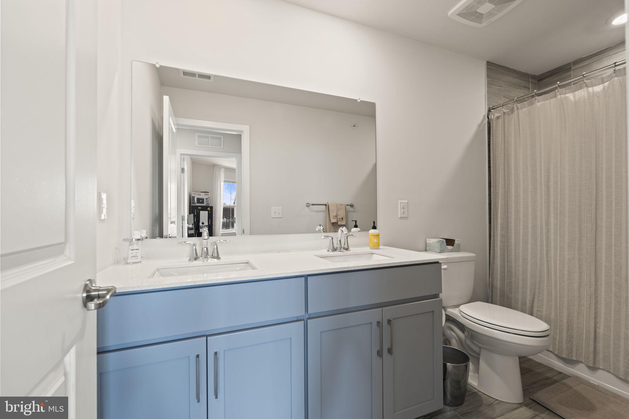 917 Anvil Court Phoenixville, PA 19460 - Photo 30 of 34 a bathroom with a toilet a sink a mirror a vanity and window