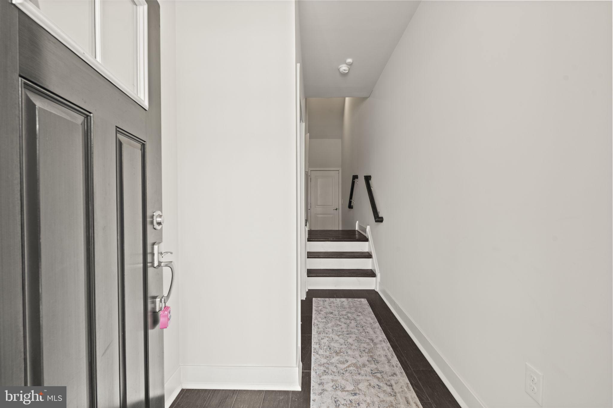 917 Anvil Court Phoenixville, PA 19460 - Photo 3 of 34 a view of a hallway with wooden floor and staircase