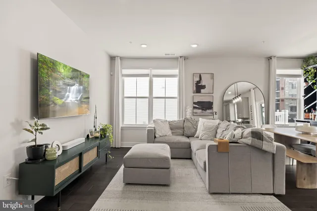 a kitchen with a sink a stove a refrigerator and white cabinets