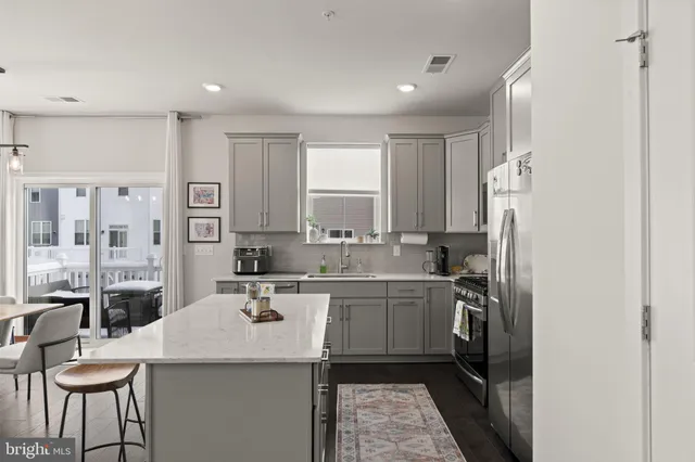 a kitchen with stainless steel appliances a refrigerator stove microwave and sink