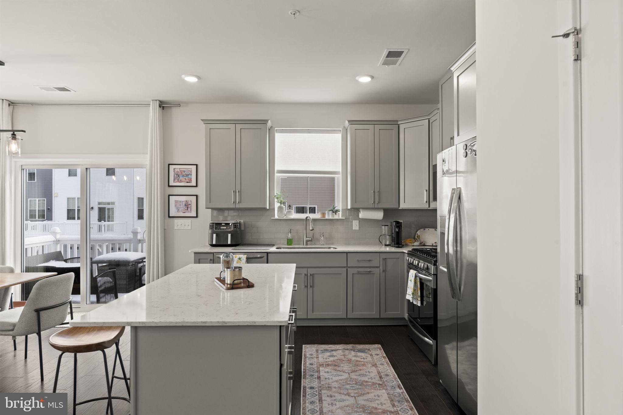 917 Anvil Court Phoenixville, PA 19460 - Photo 7 of 34 a kitchen with a sink a stove a refrigerator and white cabinets