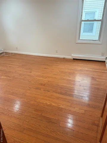 a view of room with wooden floor