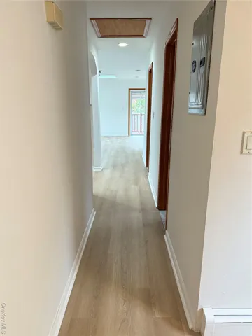 a view of a hallway with wooden floor