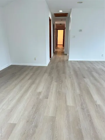 a view of a room with wooden floor and window