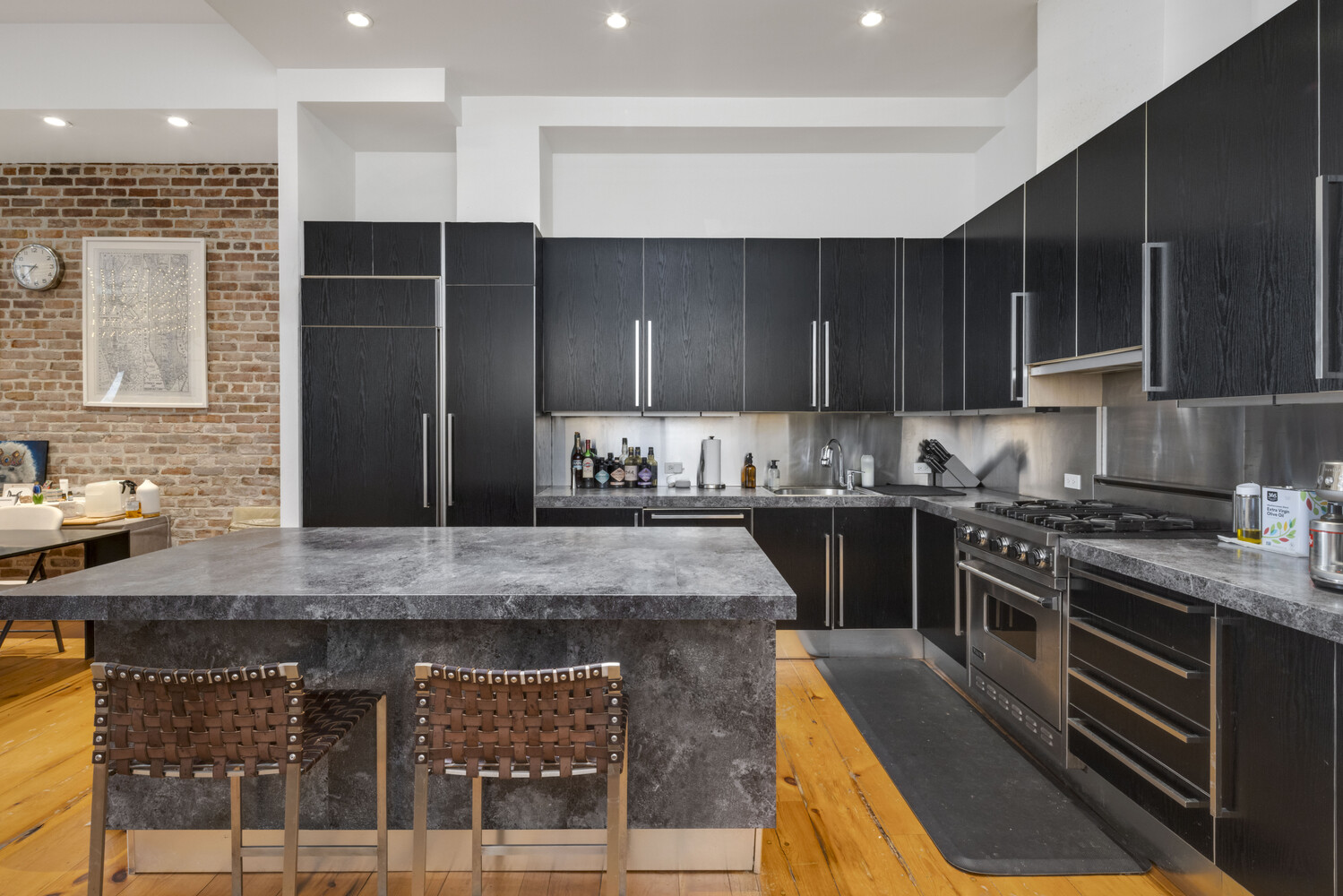8 Warren Street, Unit 2W Manhattan, NY 10007 - Photo 3 of 11 a kitchen with kitchen island granite countertop a stove a sink and a refrigerator