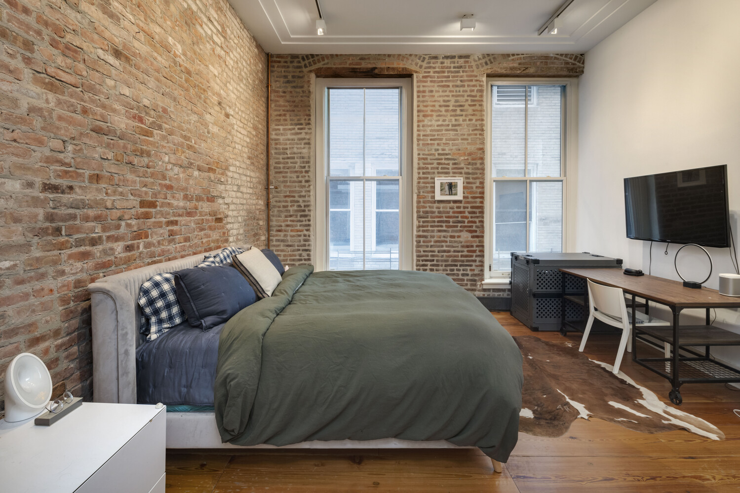 8 Warren Street, Unit 2W Manhattan, NY 10007 - Photo 5 of 11 a bedroom with a bed and a flat screen tv