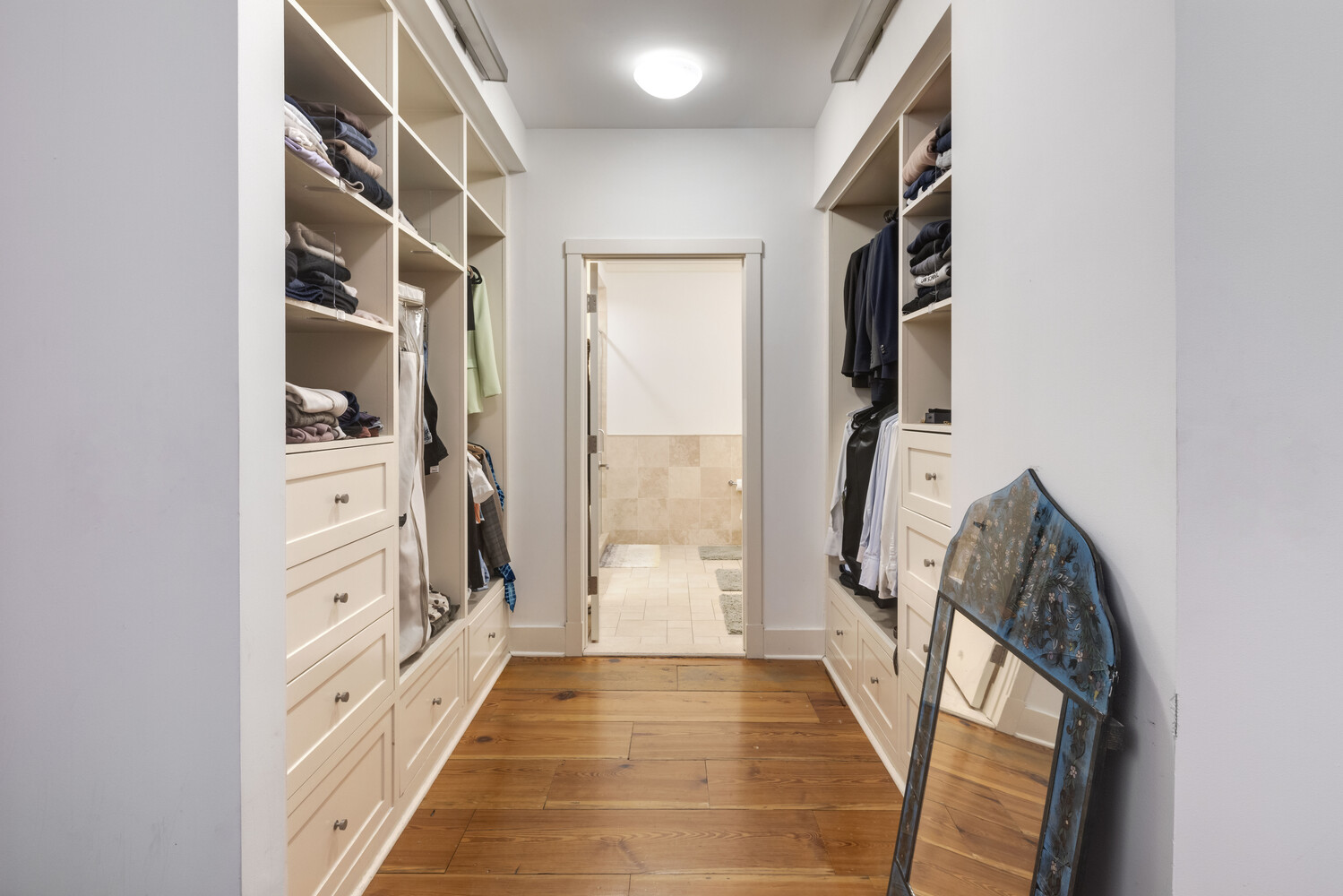 8 Warren Street, Unit 2W Manhattan, NY 10007 - Photo 6 of 11 a view of walk in closet with clothes and shoes