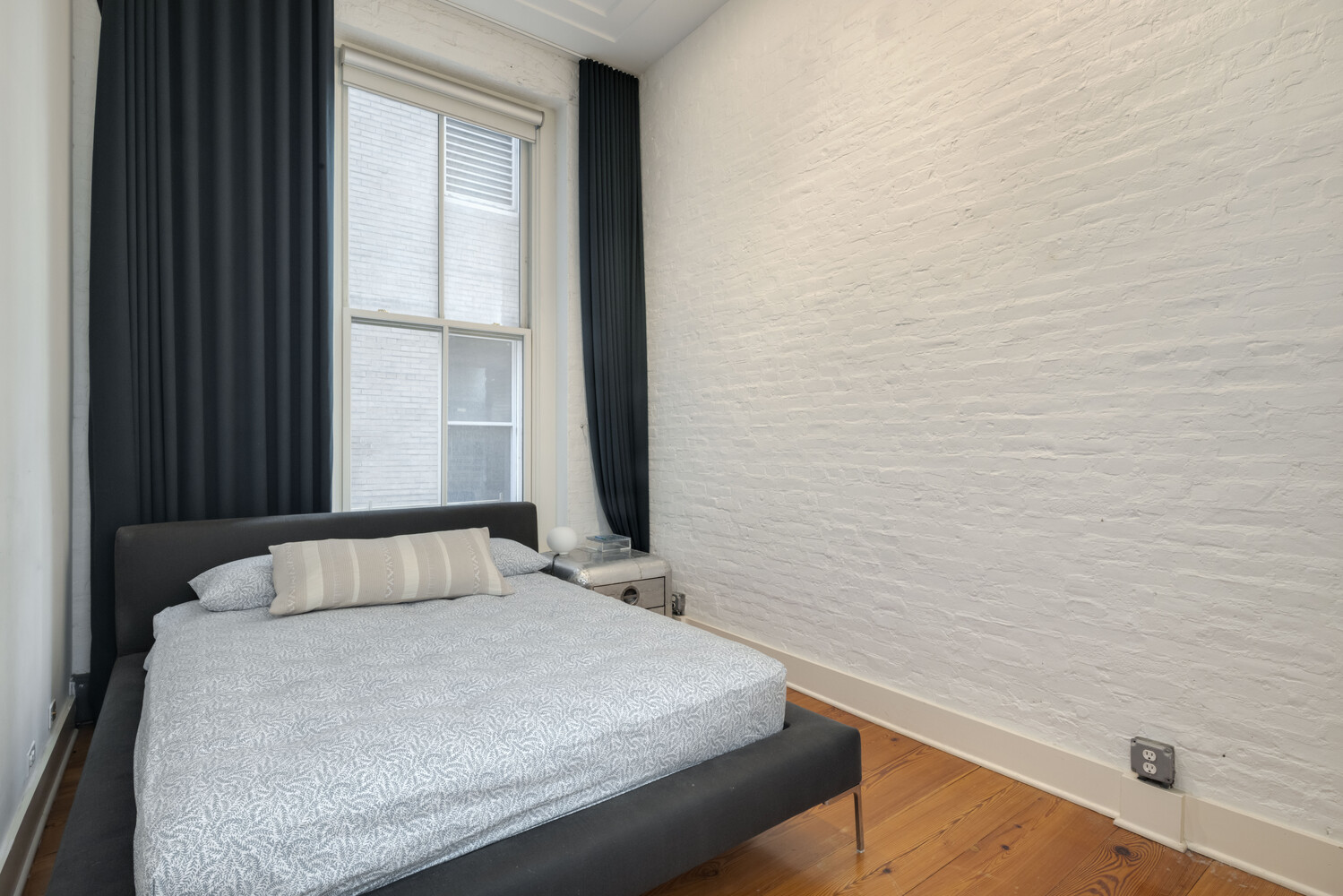 8 Warren Street, Unit 2W Manhattan, NY 10007 - Photo 7 of 11 a bedroom with a bed and a window