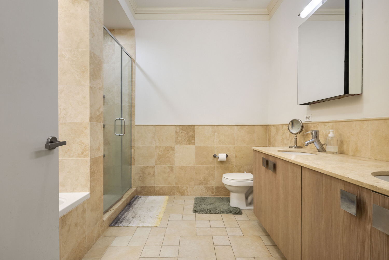 8 Warren Street, Unit 2W Manhattan, NY 10007 - Photo 8 of 11 a bathroom with a granite countertop sink toilet and shower