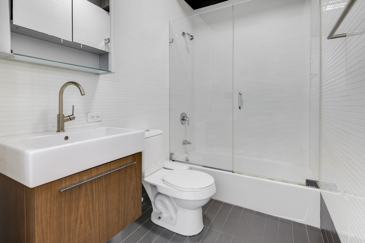 8 Warren Street, Unit 2W Manhattan, NY 10007 - Photo 9 of 11 a bathroom with a sink toilet and shower