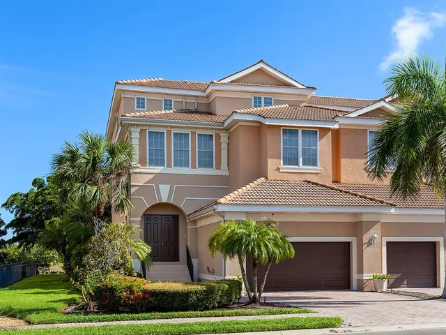 a front view of a house with a garden and plants