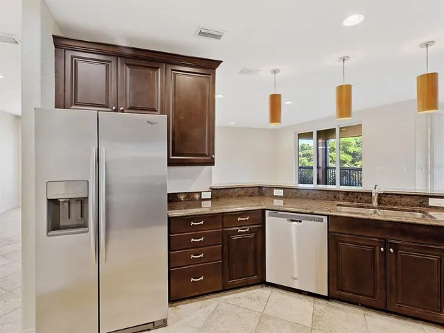 a kitchen with a sink and stainless steel appliances