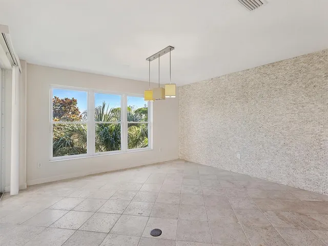 an empty room with windows and outdoor view