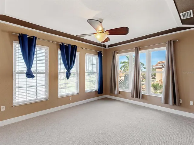 a view of an empty room with large windows