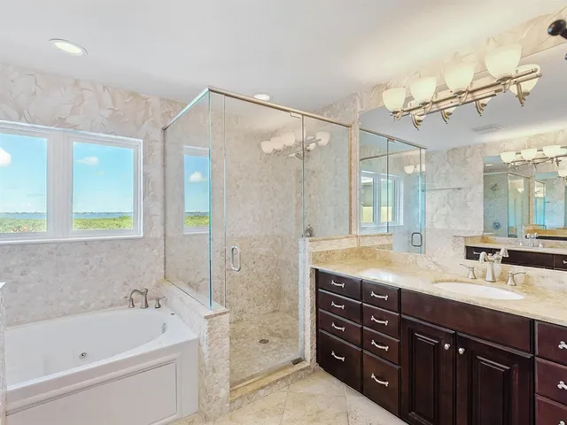 a bathroom with a double vanity sink mirror double and shower