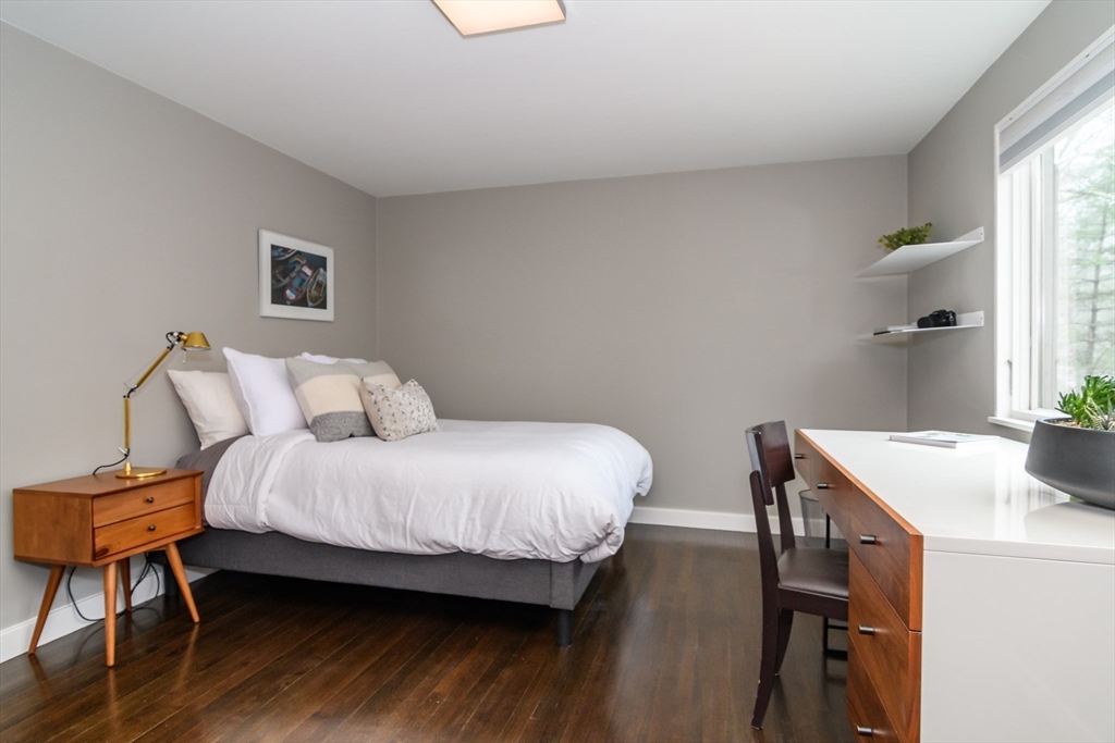 41 Grove Street Wayland, MA 01778 - Photo 14 of 24 a bedroom with a bed and a table in it