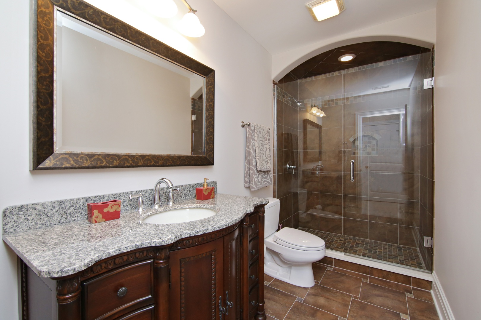 2283 Scott Road Northbrook, IL 60062 - Photo 28 of 33 a bathroom with a granite countertop sink toilet a mirror and shower